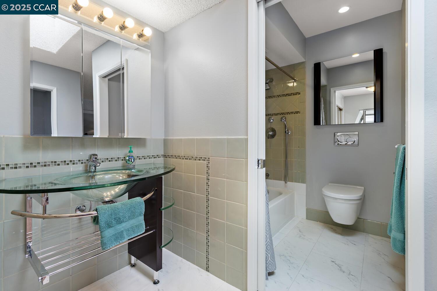 1244 Singingwood Court, Unit 1 Walnut Creek, CA 94595 - Photo 20 of 46 a bathroom with a sink a toilet and mirror