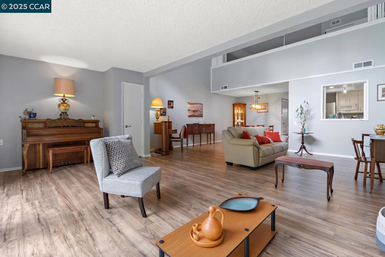 1244 Singingwood Court, Unit 1 Walnut Creek, CA 94595 - Photo 2 of 46 a living room with furniture and wooden floor