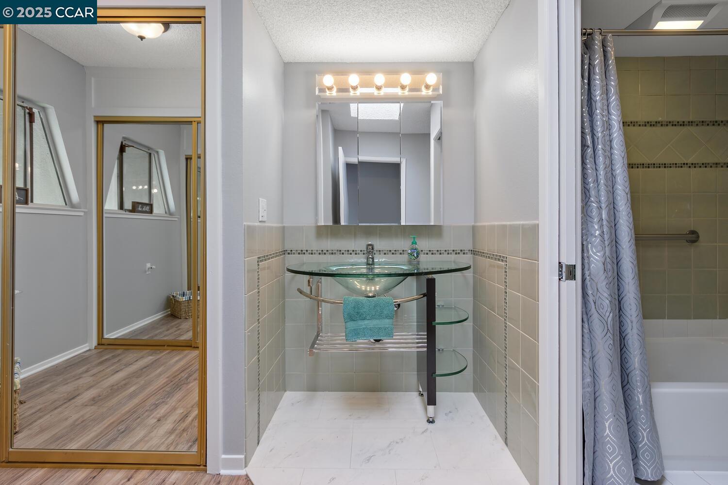 1244 Singingwood Court, Unit 1 Walnut Creek, CA 94595 - Photo 22 of 46 a view of a hallway with wooden floor and furniture