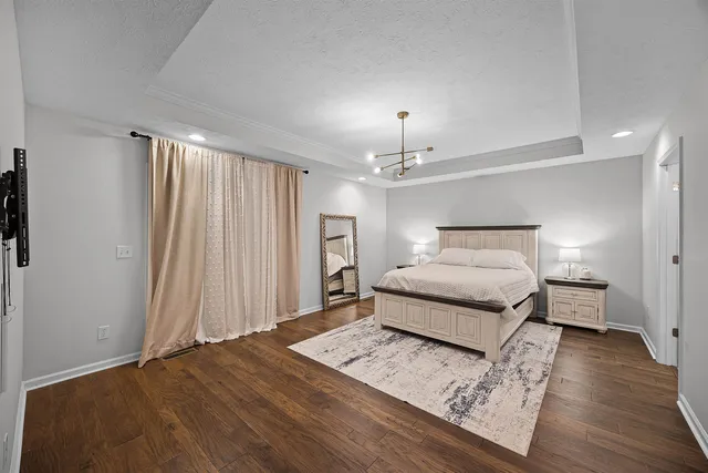 a bathroom with a granite countertop toilet double vanity and a mirror