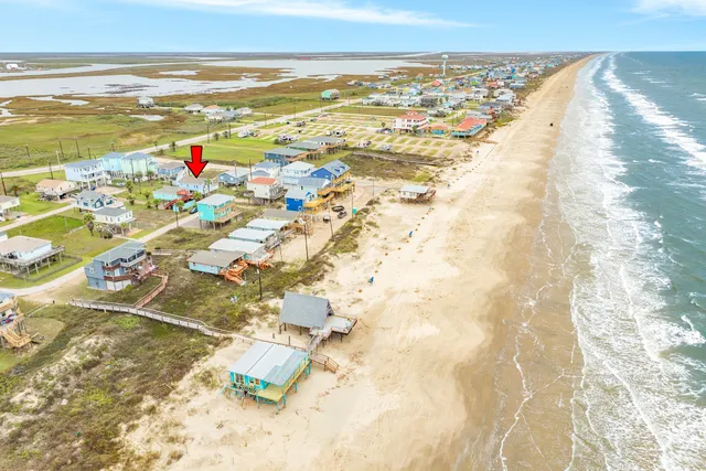 a front view of a house with glass windows and a yard