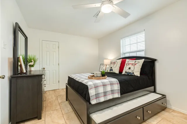 a bedroom with a bed and a dresser