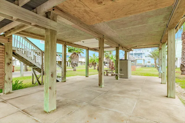 a view of a patio with a table and chairs