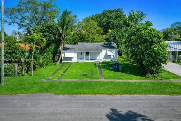 a front view of a house with a yard and a porch
