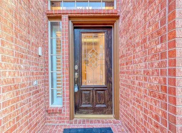 a view of a brick house with a door and a window