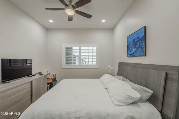 a bedroom with a bed and a table
