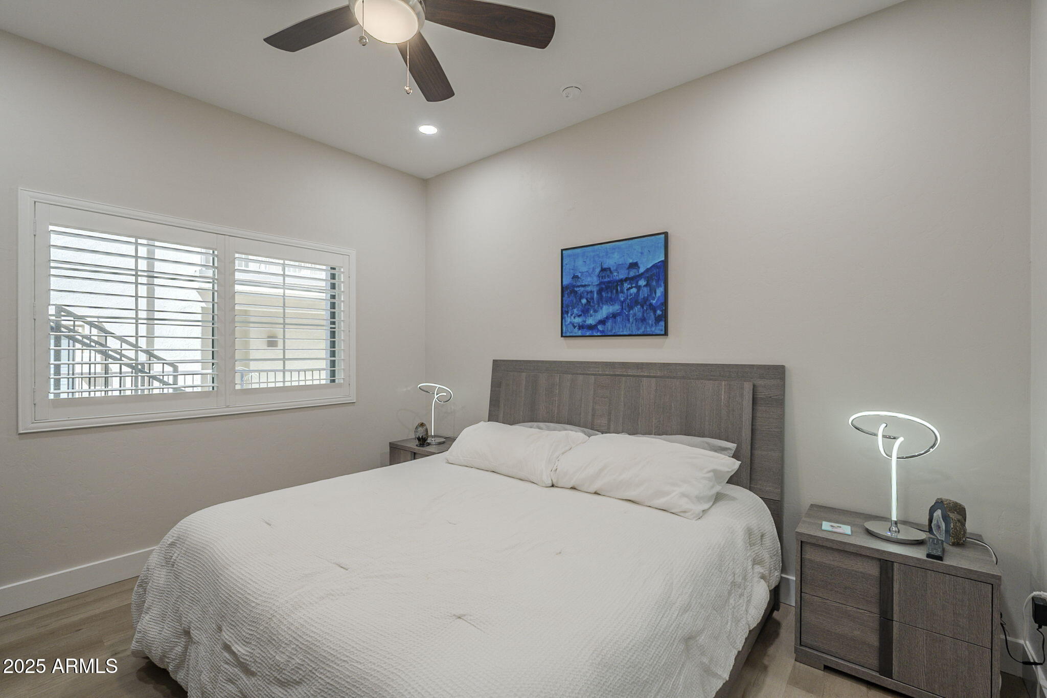 2038 East River Road, Unit 101 Tucson, AZ 85718 - Photo 13 of 21 a large bed sitting in a bedroom next to a window