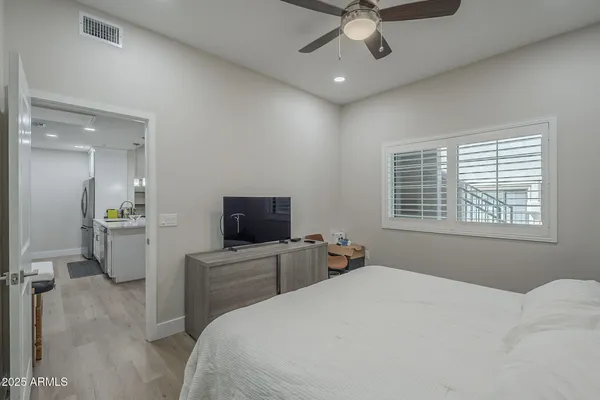 a large bed sitting in a bedroom next to a window