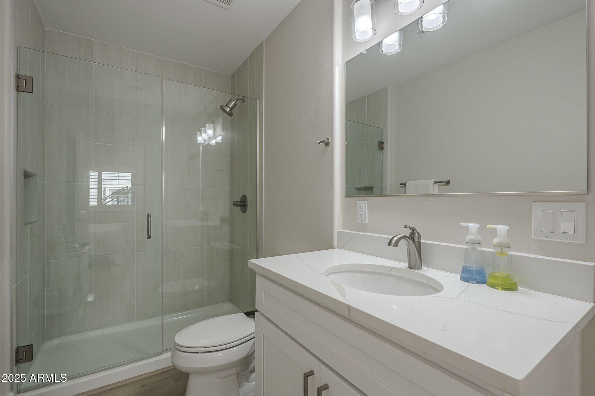 2038 East River Road, Unit 101 Tucson, AZ 85718 - Photo 15 of 21 a bathroom with a sink toilet and shower