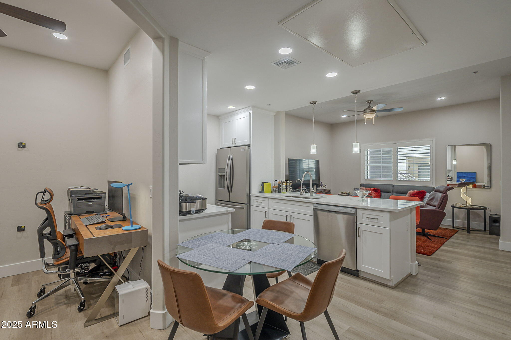 2038 East River Road, Unit 101 Tucson, AZ 85718 - Photo 2 of 21 a kitchen with stainless steel appliances kitchen island granite countertop a sink and cabinets