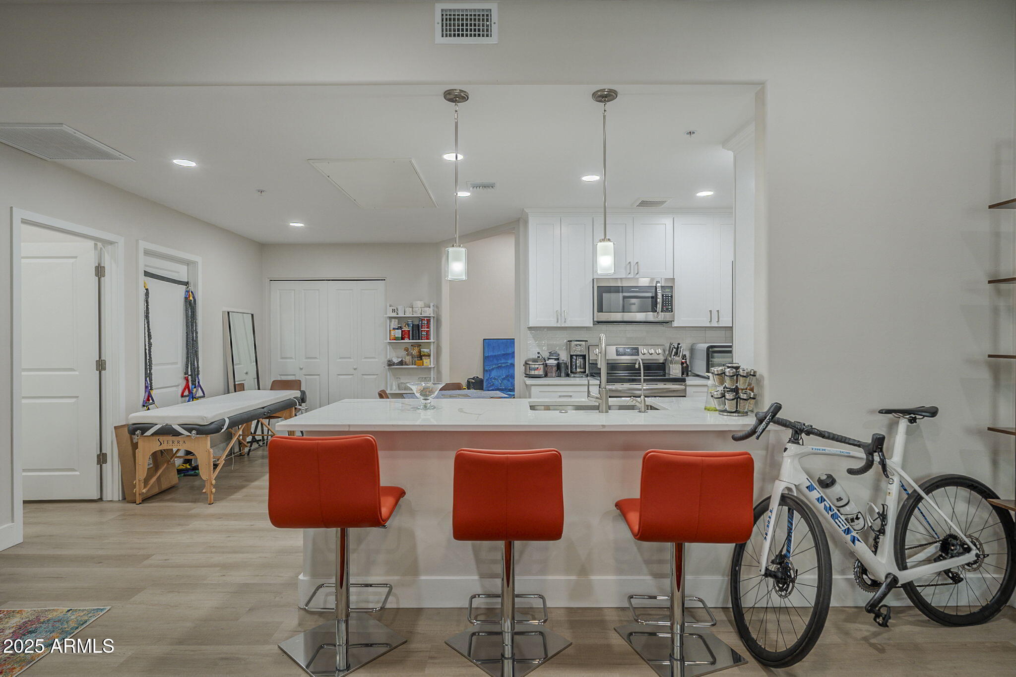 2038 East River Road, Unit 101 Tucson, AZ 85718 - Photo 6 of 21 a kitchen with stainless steel appliances granite countertop a table chairs stove and sink