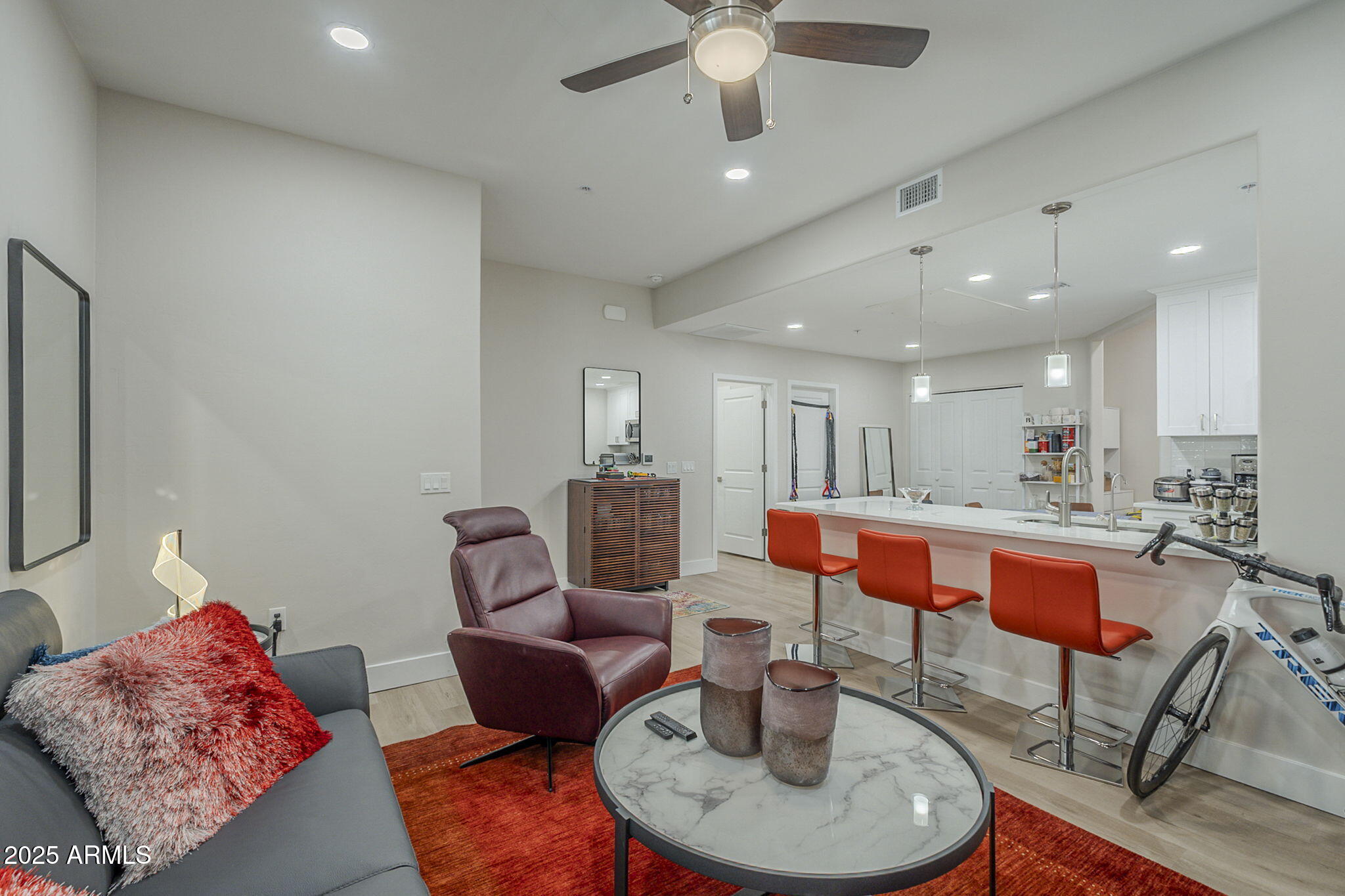 2038 East River Road, Unit 101 Tucson, AZ 85718 - Photo 8 of 21 a living room with furniture a rug and a chandelier