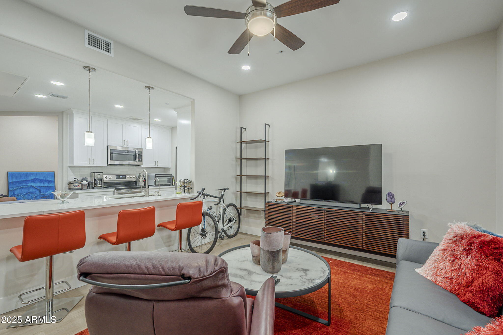 2038 East River Road, Unit 101 Tucson, AZ 85718 - Photo 9 of 21 a living room with furniture and a flat screen tv