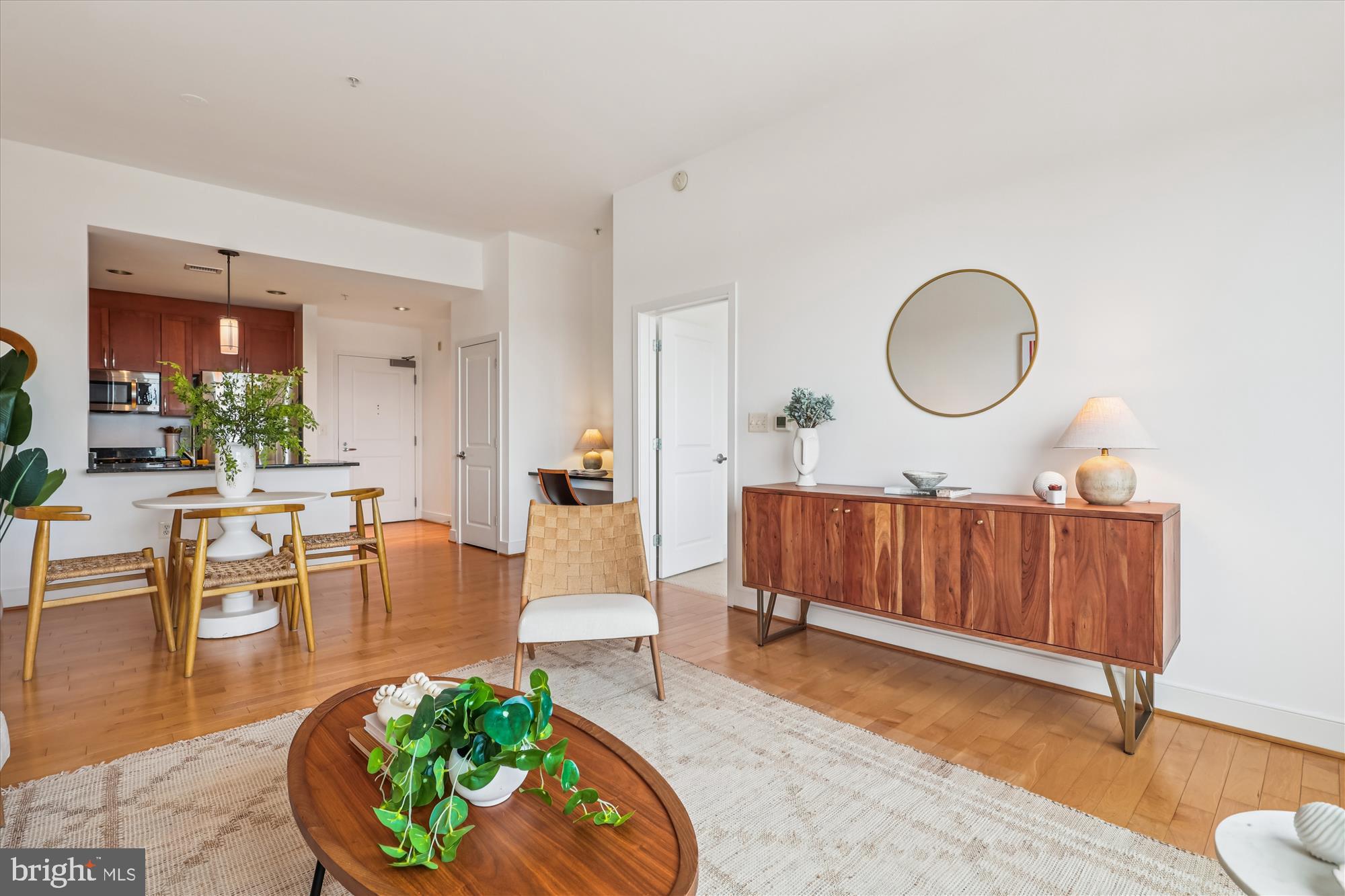 4101 Albemarle Street Northwest, Unit 623 Washington, DC 20016 - Photo 13 of 25 a living room with furniture a mirror and wooden floor