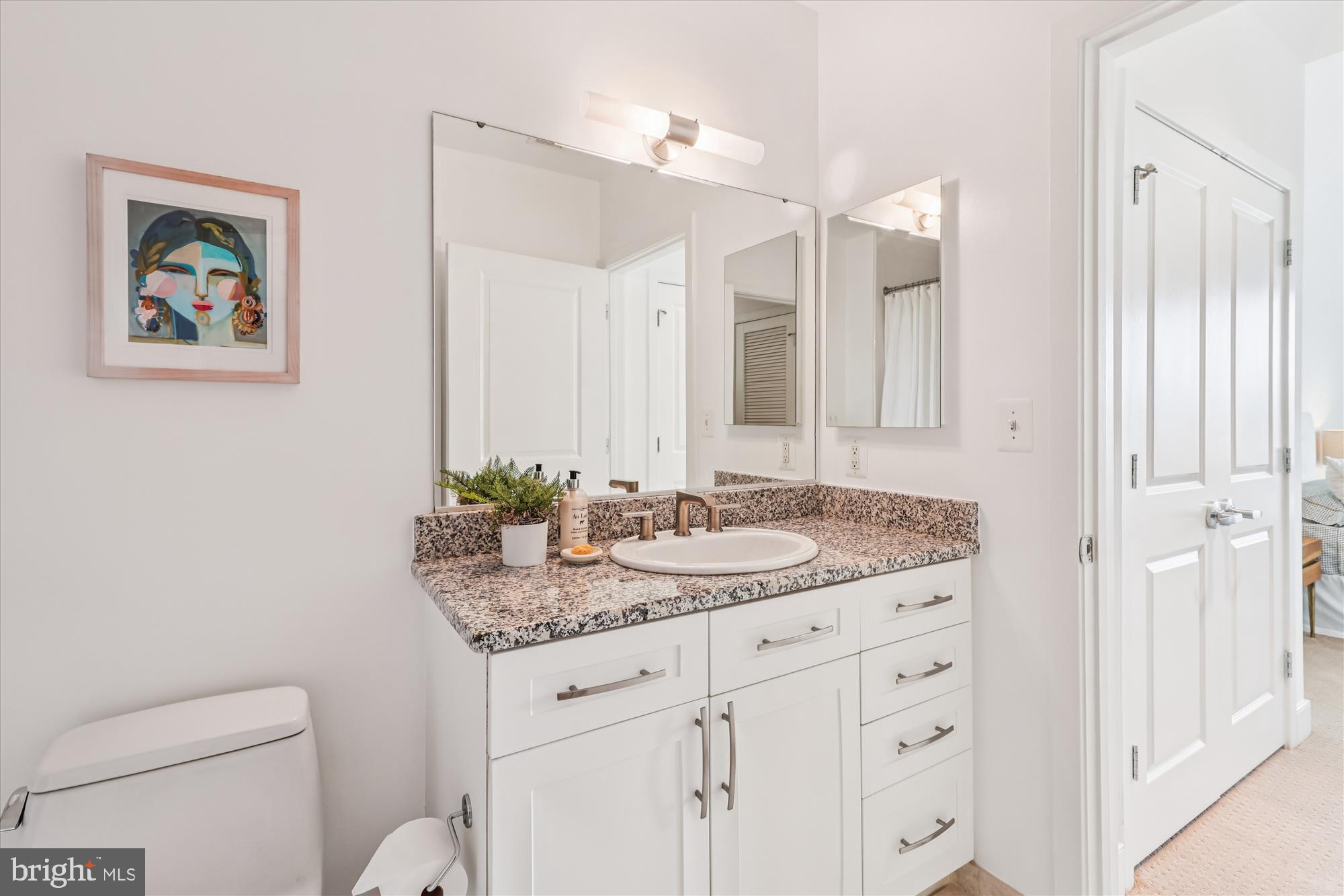 4101 Albemarle Street Northwest, Unit 623 Washington, DC 20016 - Photo 17 of 25 a bathroom with a granite countertop sink mirror and toilet