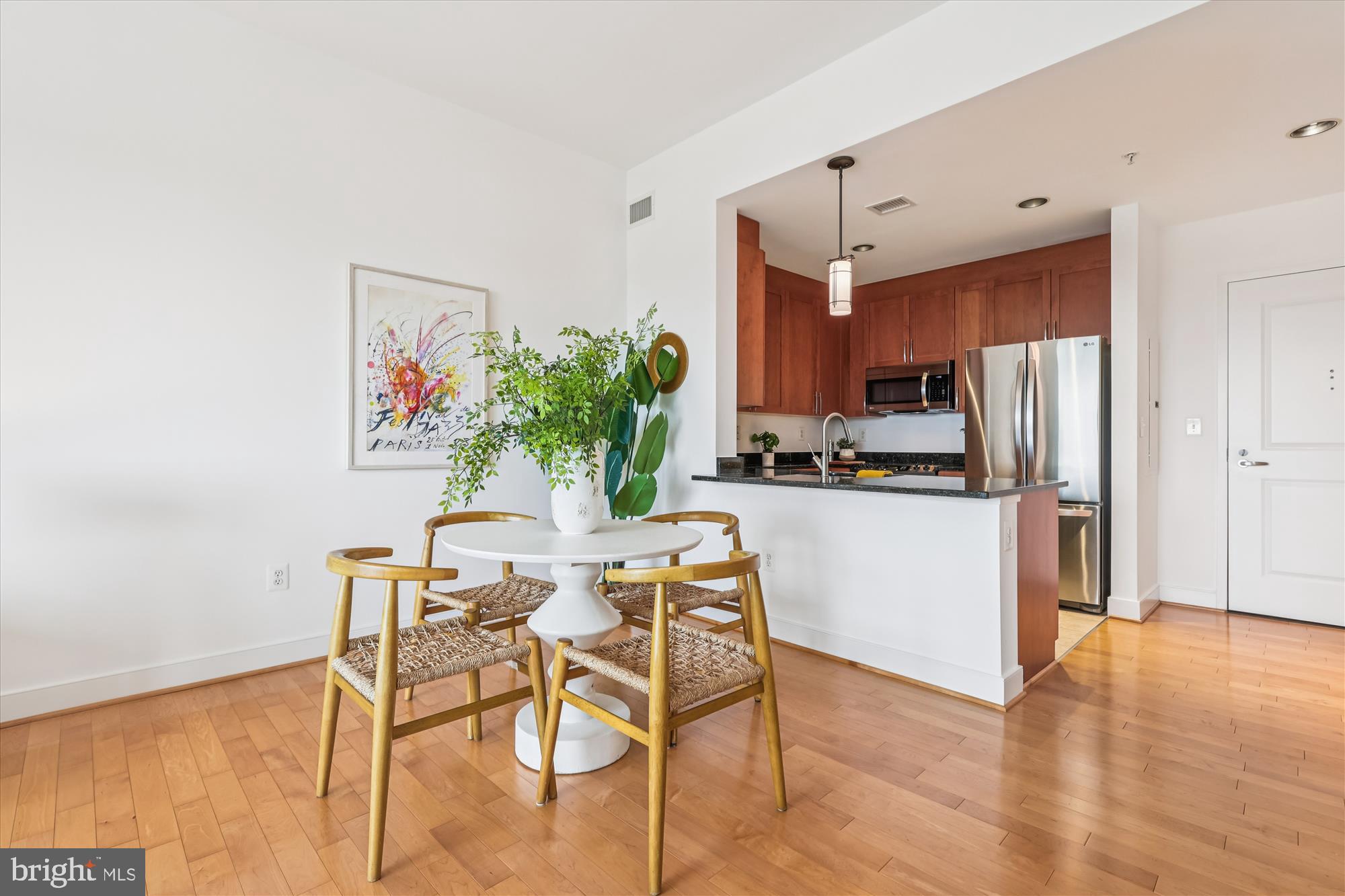 4101 Albemarle Street Northwest, Unit 623 Washington, DC 20016 - Photo 7 of 25 a kitchen with stainless steel appliances a refrigerator and a dining table
