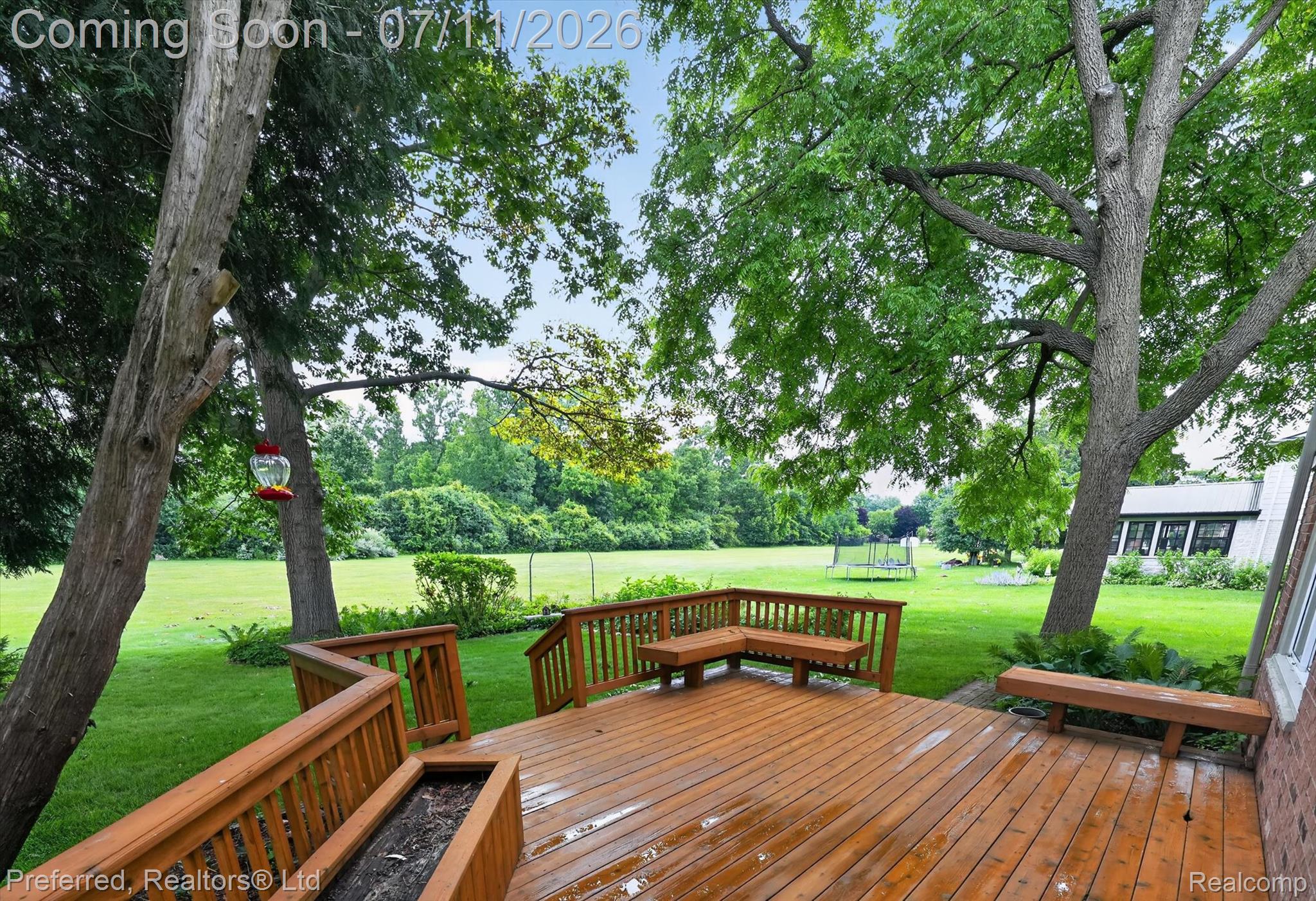 46596 Maidstone Road Canton, MI 48187 - Photo 47 of 61 Expansive wood-finish deck with built-in seating and planters