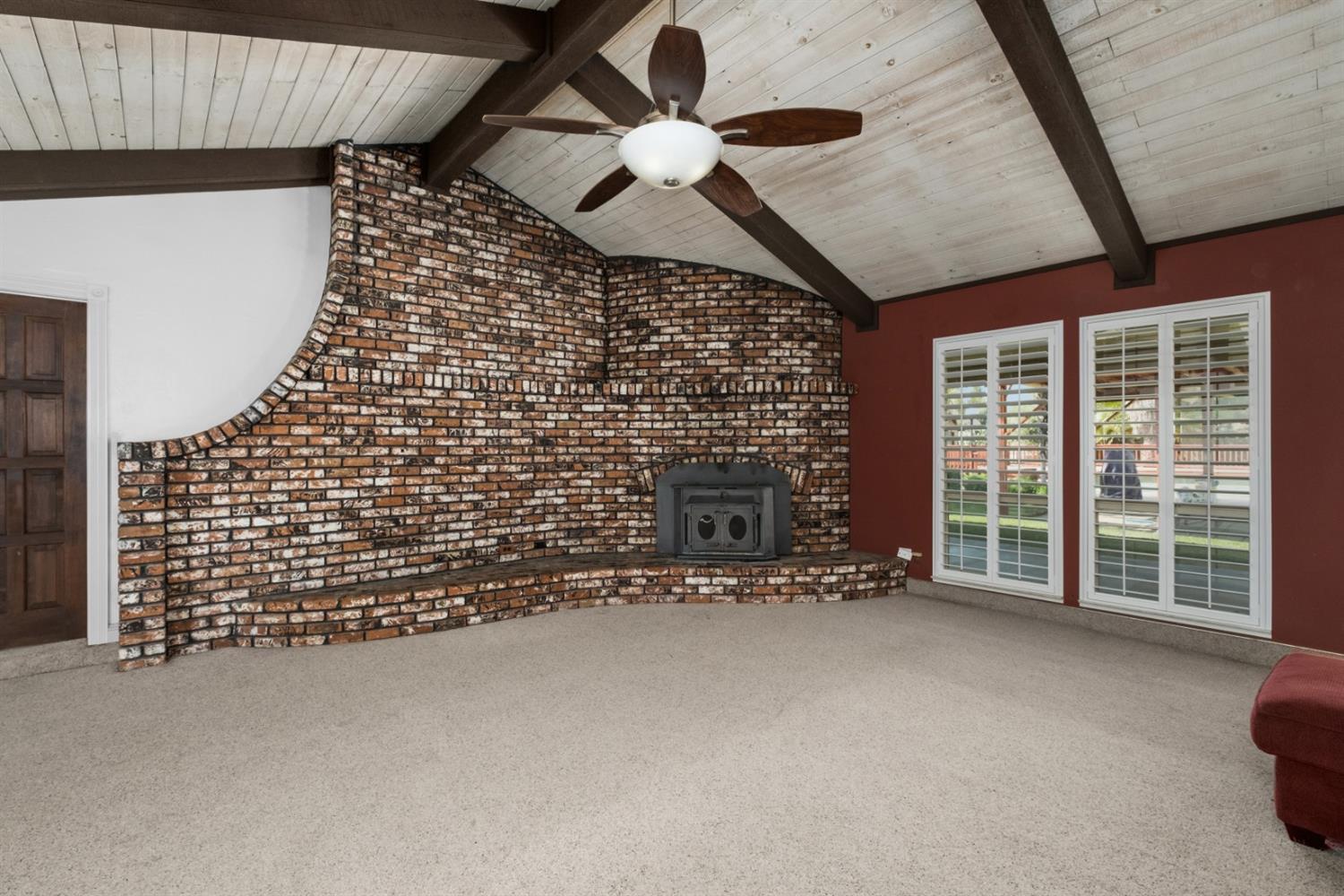 3140 North Temperance Avenue Clovis, CA 93611 - Photo 12 of 36 a view of an empty room with a fireplace and a ceiling fan