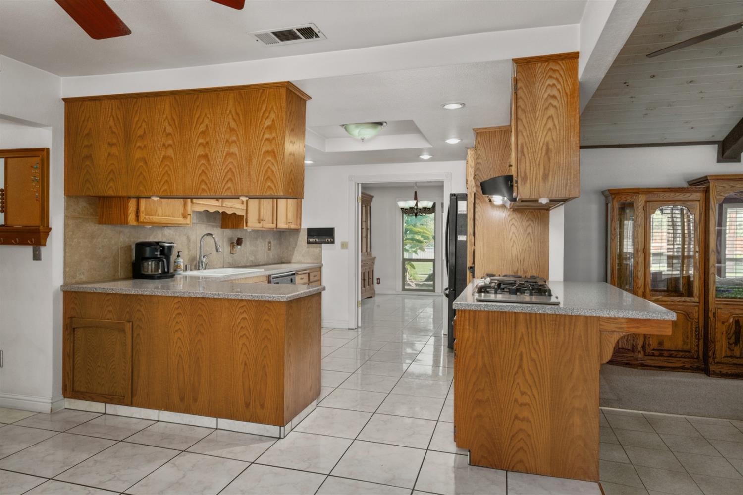 3140 North Temperance Avenue Clovis, CA 93611 - Photo 16 of 36 a kitchen with a sink a counter top space and cabinets