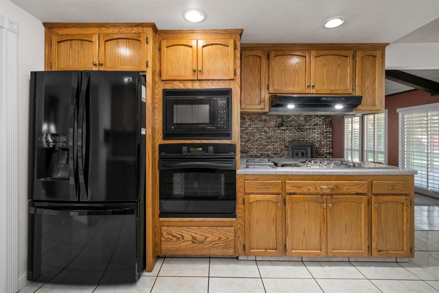 3140 North Temperance Avenue Clovis, CA 93611 - Photo 18 of 36 a kitchen with stainless steel appliances granite countertop a refrigerator and a stove top oven
