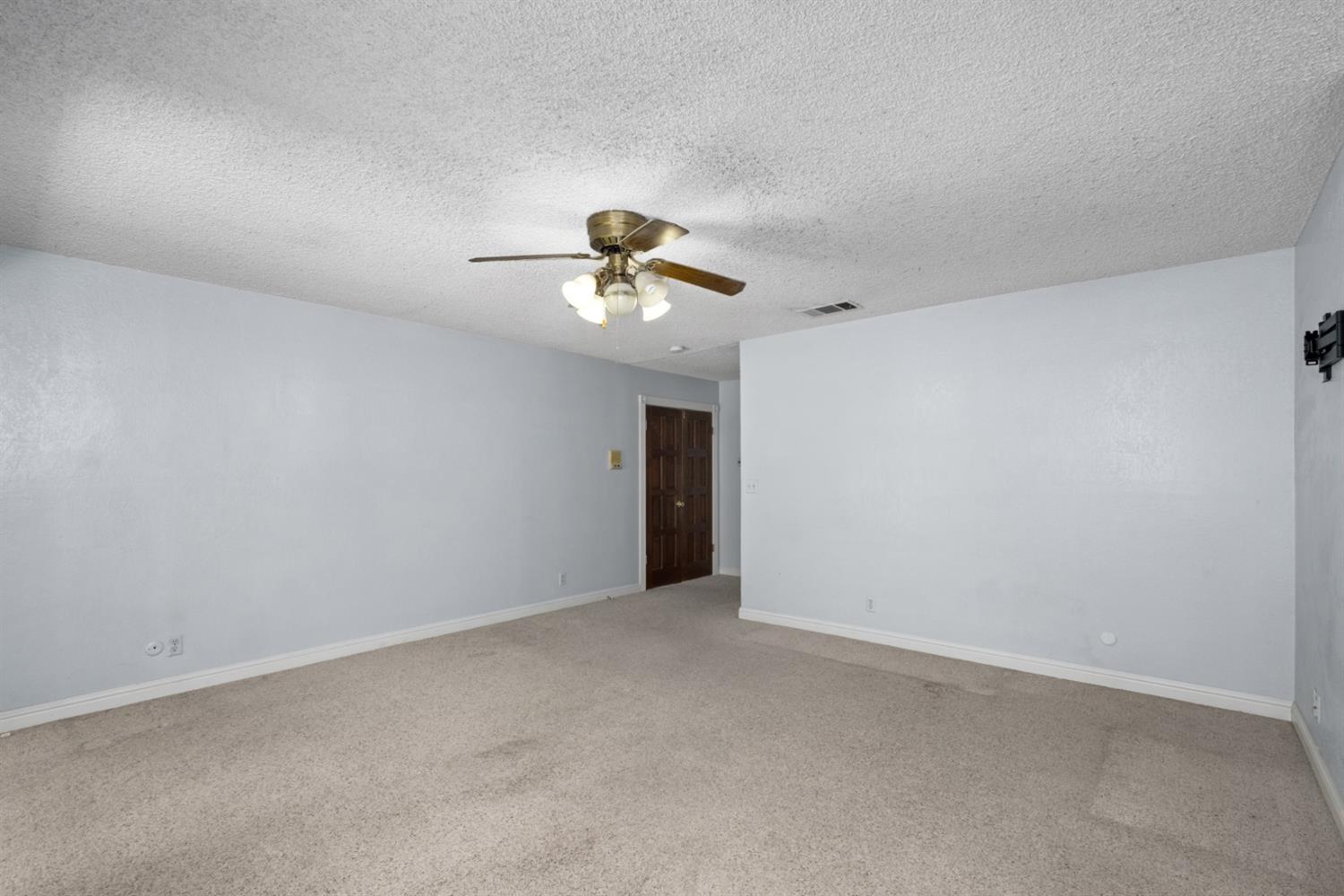 3140 North Temperance Avenue Clovis, CA 93611 - Photo 22 of 36 a view of an empty room with a chandelier fan