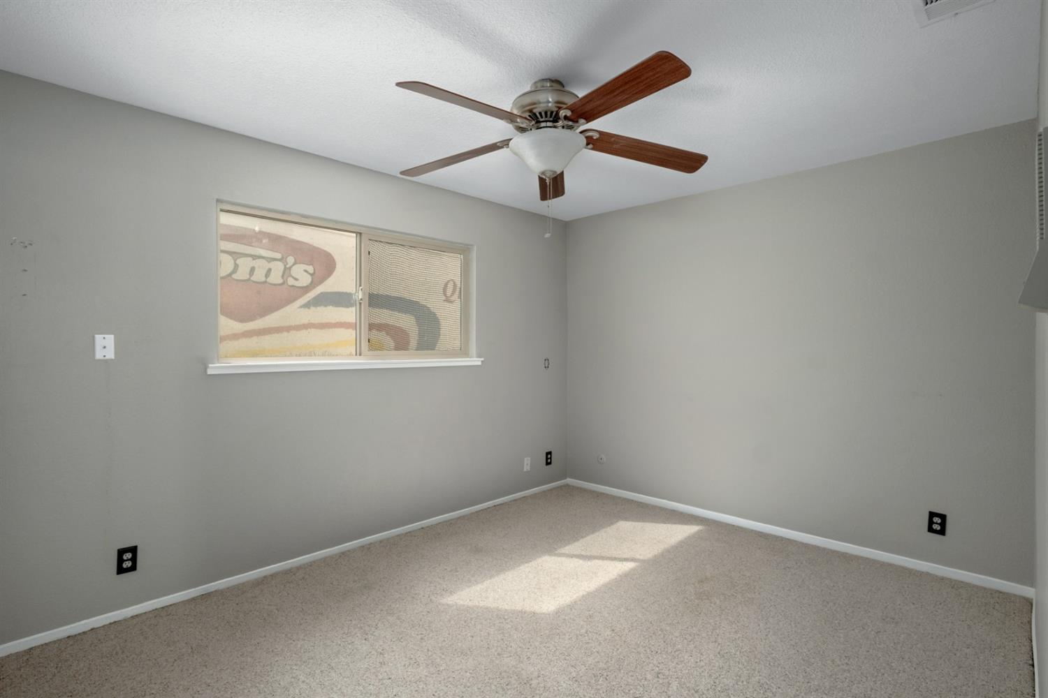 3140 North Temperance Avenue Clovis, CA 93611 - Photo 25 of 36 an empty room with a window and a fan