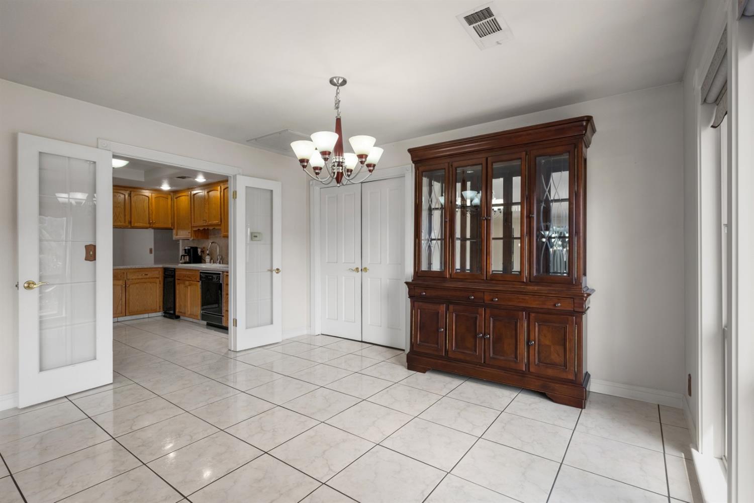 3140 North Temperance Avenue Clovis, CA 93611 - Photo 10 of 36 a view of a hallway with wooden floor and chandelier