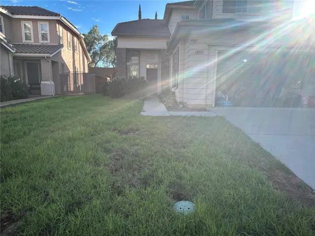 a view of a brick house with a yard
