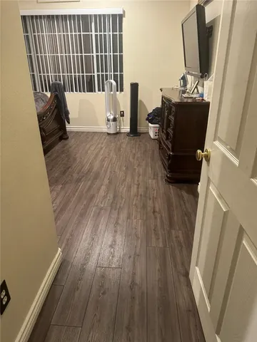 a view of a hardwood floor and wardrobe