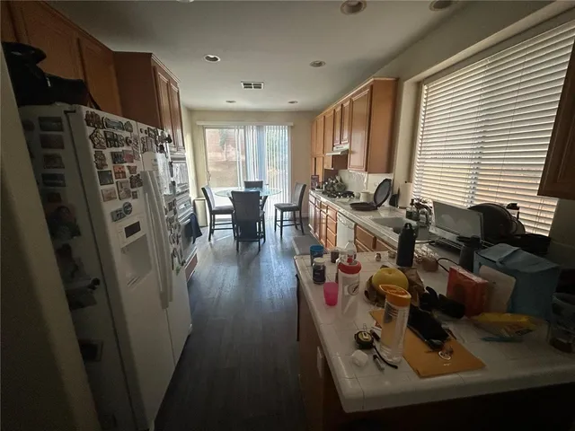 a view of a livingroom with furniture hardwood floor and a window