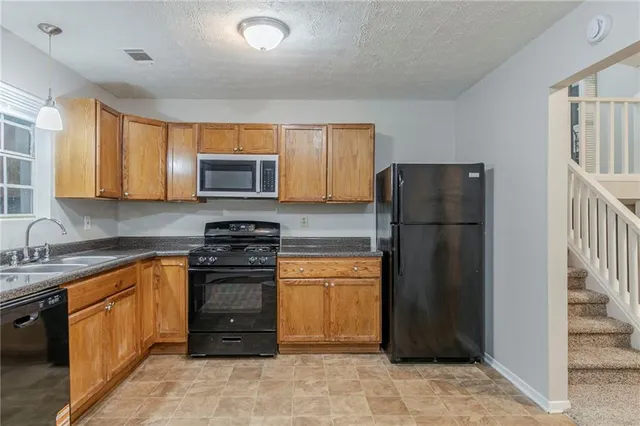 a kitchen with a refrigerator and a sink