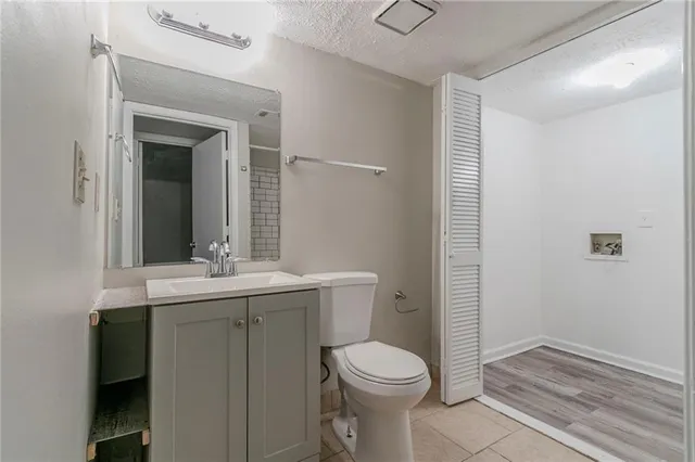 a bathroom with a toilet a sink and mirror