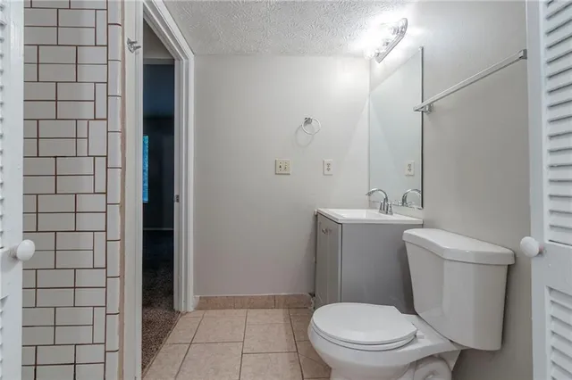 a bathroom with a toilet a sink and shower
