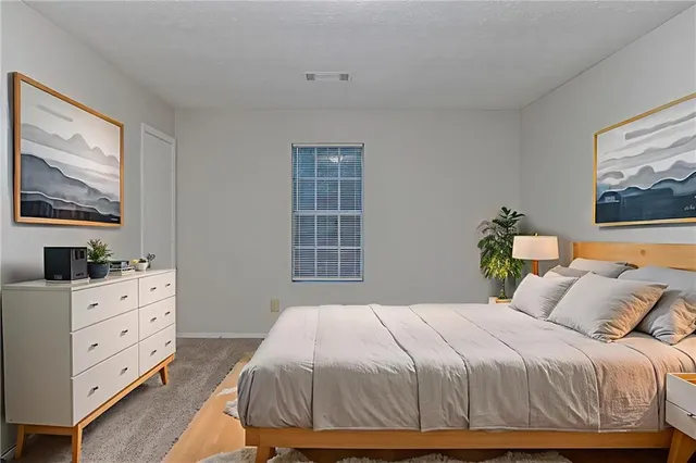 a bedroom with a bed and window