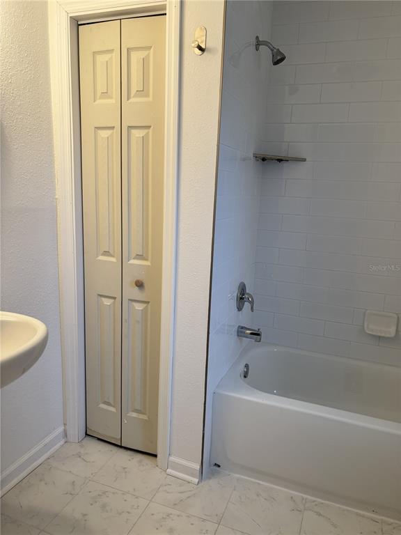 9030 Blind Pass Road, Unit C7 St. Petersburg, FL 33706 - Photo 14 of 16 a bathroom with a bathtub and a shower