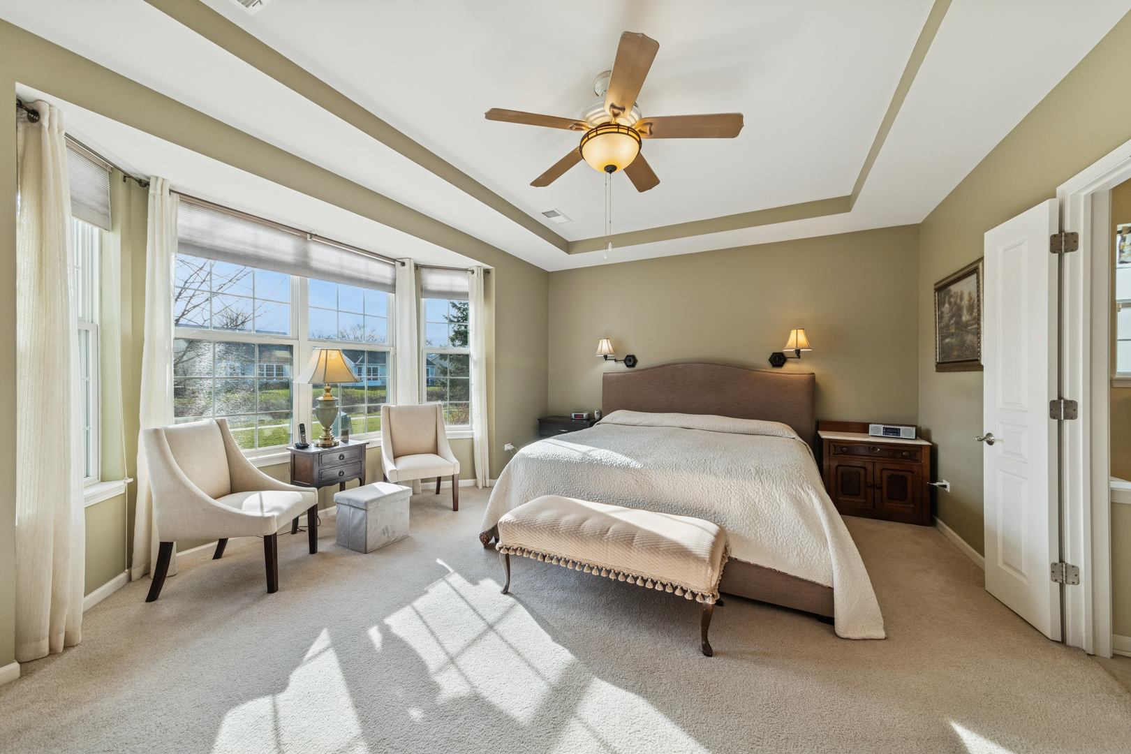 2545 Edgewater Drive Elgin, IL 60124 - Photo 11 of 21 a bedroom with a bed a chandelier and a large window