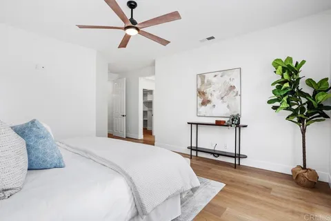a bedroom with a bed and a potted plant