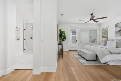 a spacious bedroom with a bed closet and chandelier