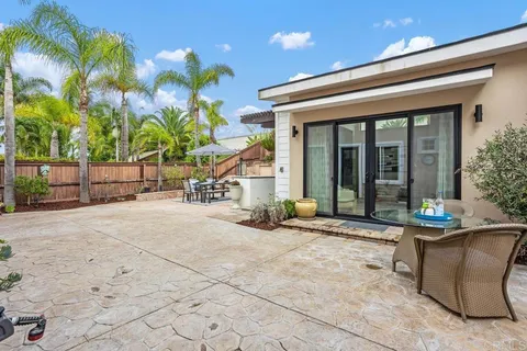 a view of a house with backyard and sitting area