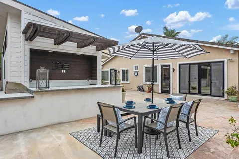 a view of a patio with table and chairs with wooden floor