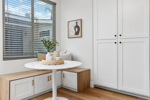 a room with a sink cabinets and a window