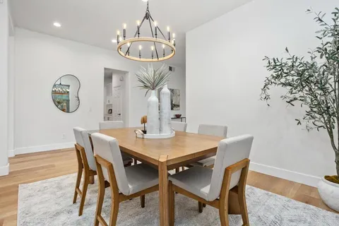 a view of a dining room with furniture and chandelier