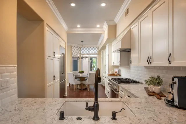 a kitchen with stainless steel appliances kitchen island granite countertop a sink and cabinets