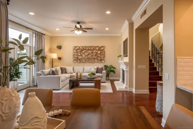 a living room with furniture and wooden floor