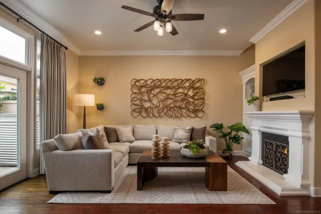 a living room with furniture a flat screen tv and a fireplace