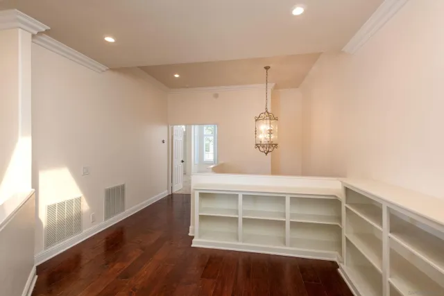 a view of a room with wooden floor and windows