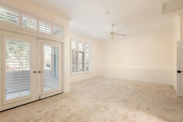 an empty room with windows and closet