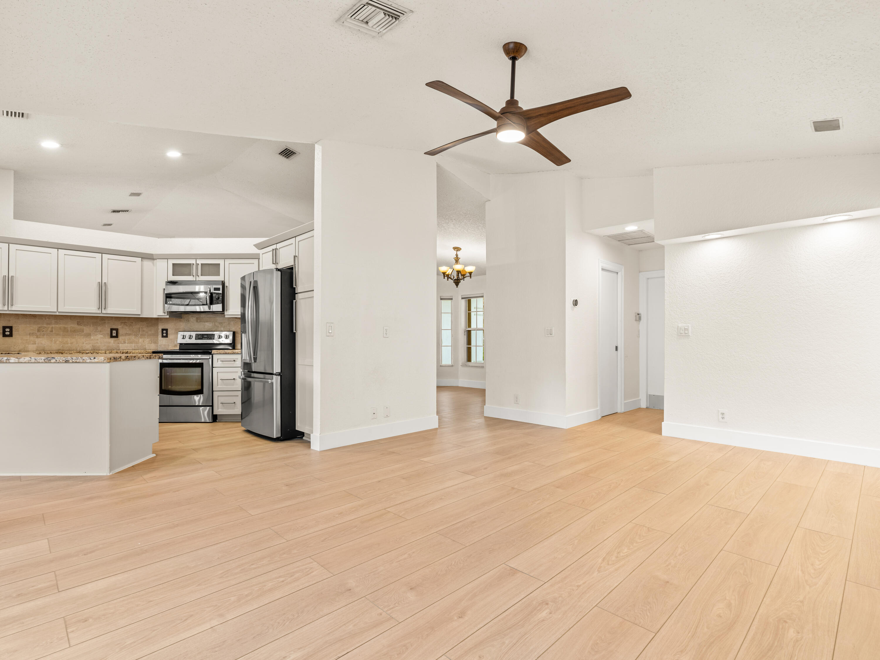 833 Heron Road Weston, FL 33326 - Photo 11 of 34 a view of a kitchen with a sink and a refrigerator