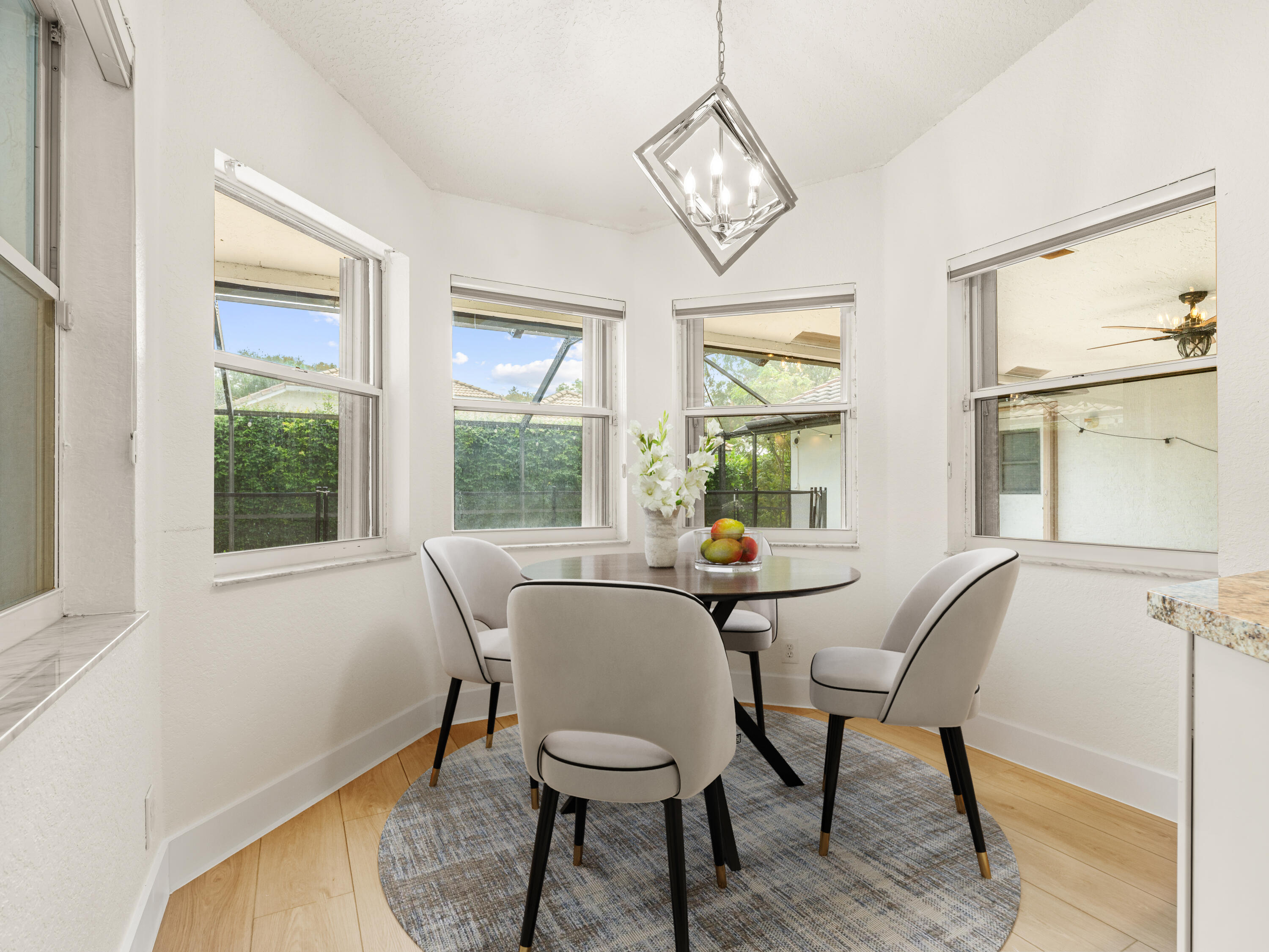833 Heron Road Weston, FL 33326 - Photo 13 of 34 a view of a dining room with furniture wooden floor and a chandelier