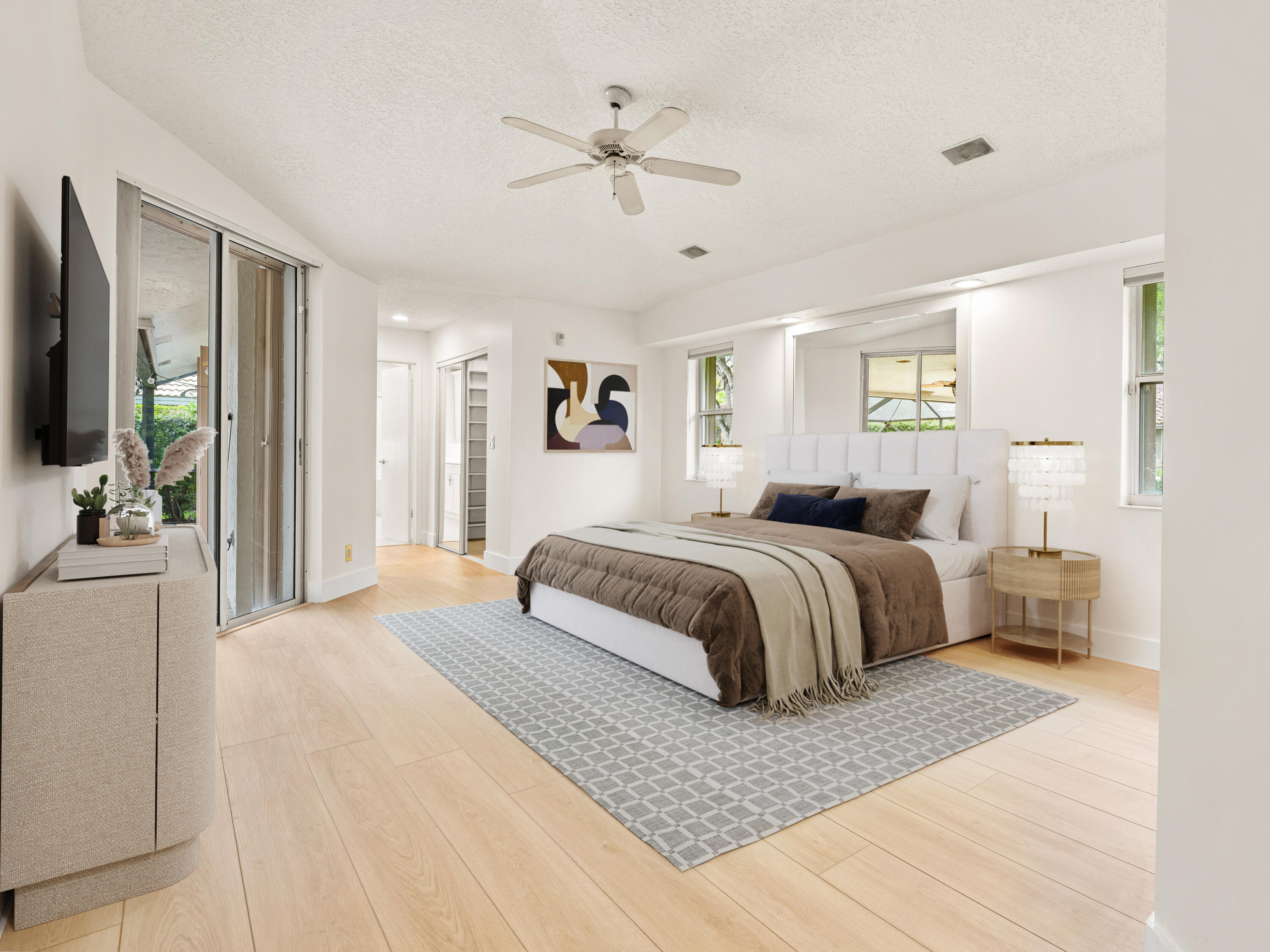 833 Heron Road Weston, FL 33326 - Photo 15 of 34 a bedroom with a large bed a chandelier and dresser
